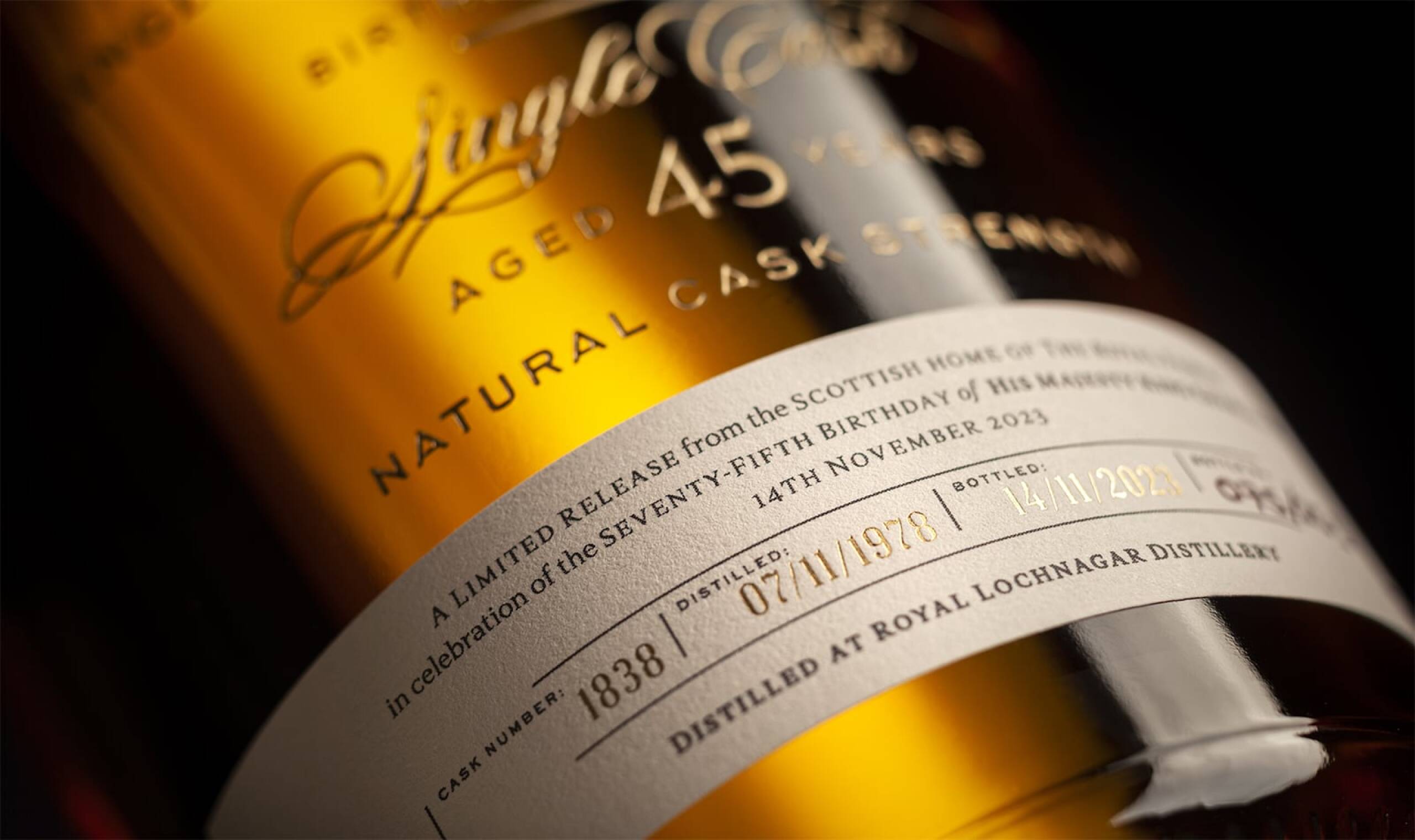 Close-up of a whisky bottle label reading Single Cask Aged 45 Years Natural Cask Strength. It marks a limited release for King Charles III's 75th birthday.